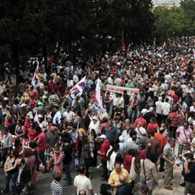 Thousands of people gather outside the ERT greek state television headquarters, during a 24-hour strike to support of the ERT employees and the state television status in Athens on June 13, 2013.  Greece's government shut down the   state broadcaster's operations , a  shock move affecting nearly 2,700 jobs. The Greek government said  it will reorganise the state broadcasting company after it abruptly pulled the plug on ERT as part of its austerity drive. AFP PHOTO/ LOUISA GOULIAMAKI        (Photo credit should read LOUISA GOULIAMAKI/AFP/Getty Images)